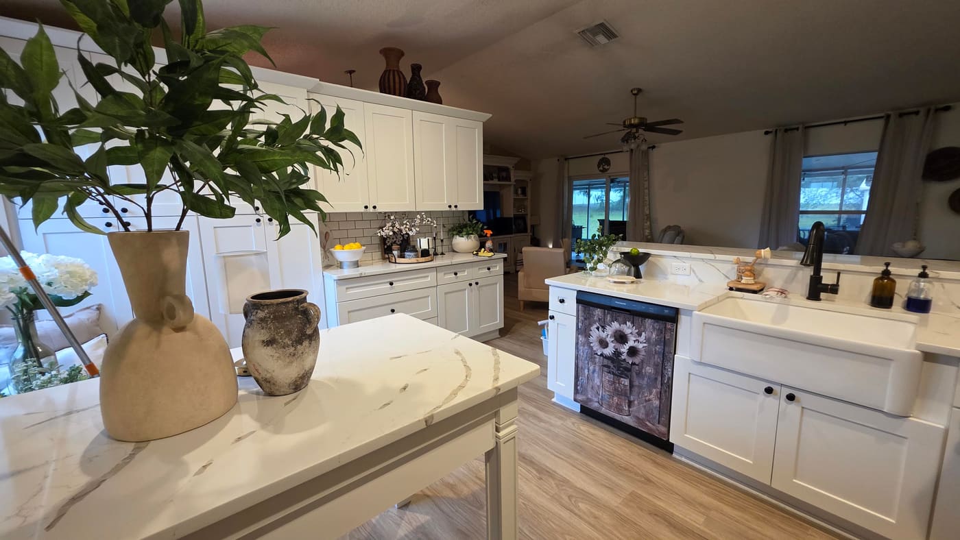 Bright white kitchen with a gleaming marble island